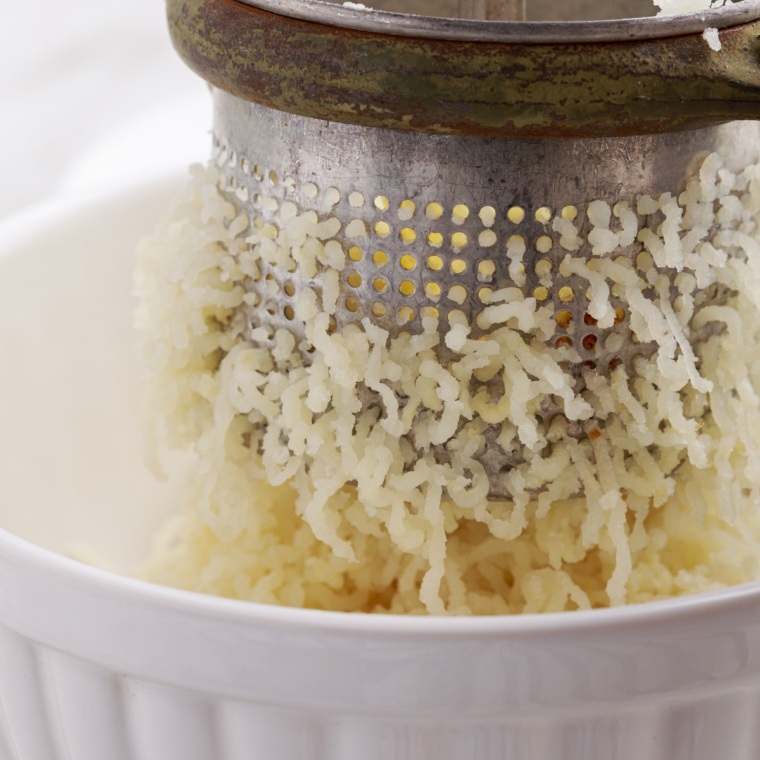 Creamy air fryer mashed potatoes in a bowl with butter melting into fluffy texture no boil easy side dish recipe.