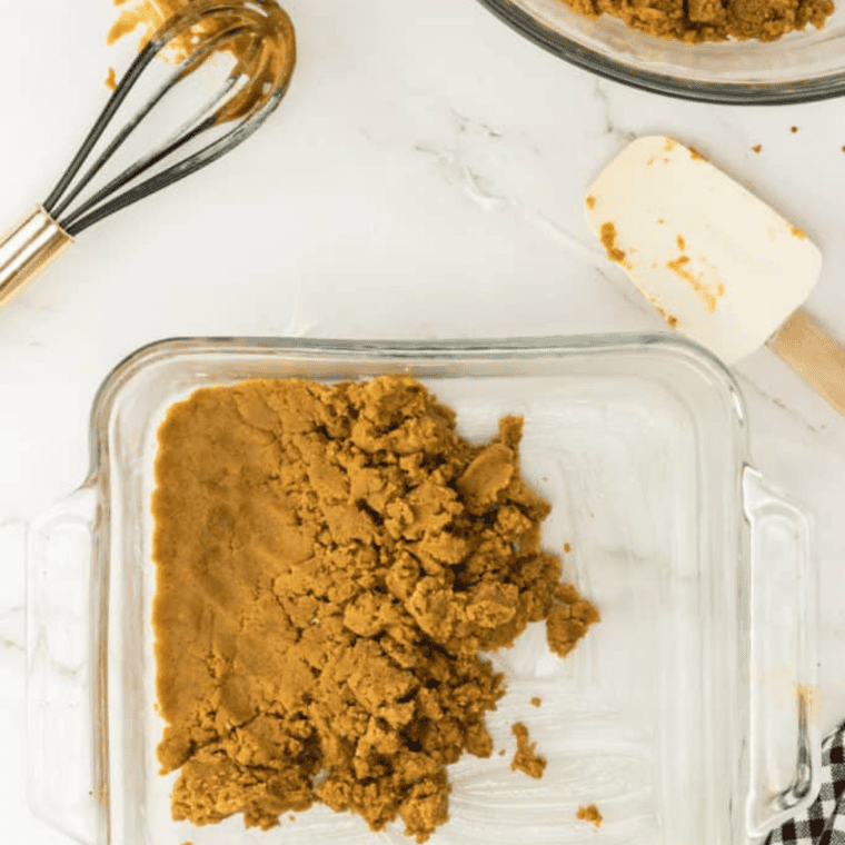 Scooping and rolling peanut butter cookie dough into 1-tablespoon balls, coating in sugar.