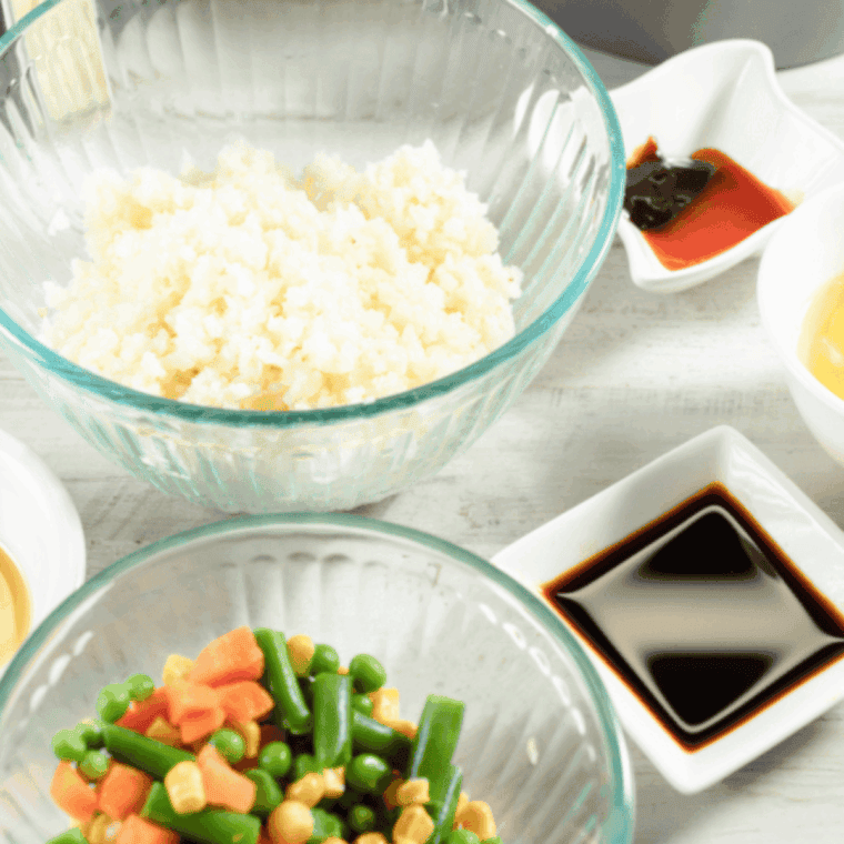 Diced chicken tossed with oil, salt, and pepper cooking in an air fryer until golden brown and fully cooked.