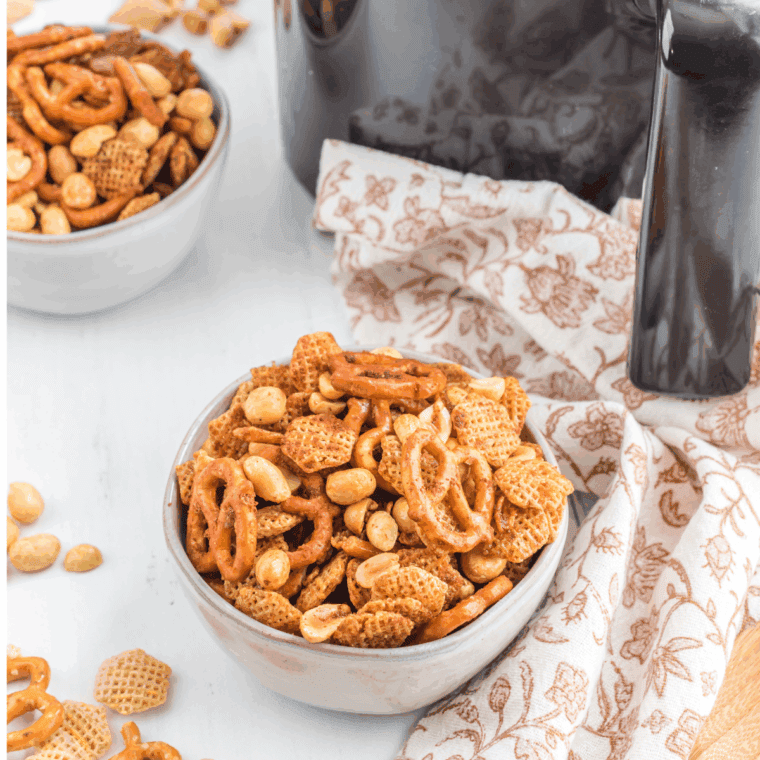 Easy Air Fryer Chex Mix with cereal, nuts, pretzels, and seasoned butter tossed together.