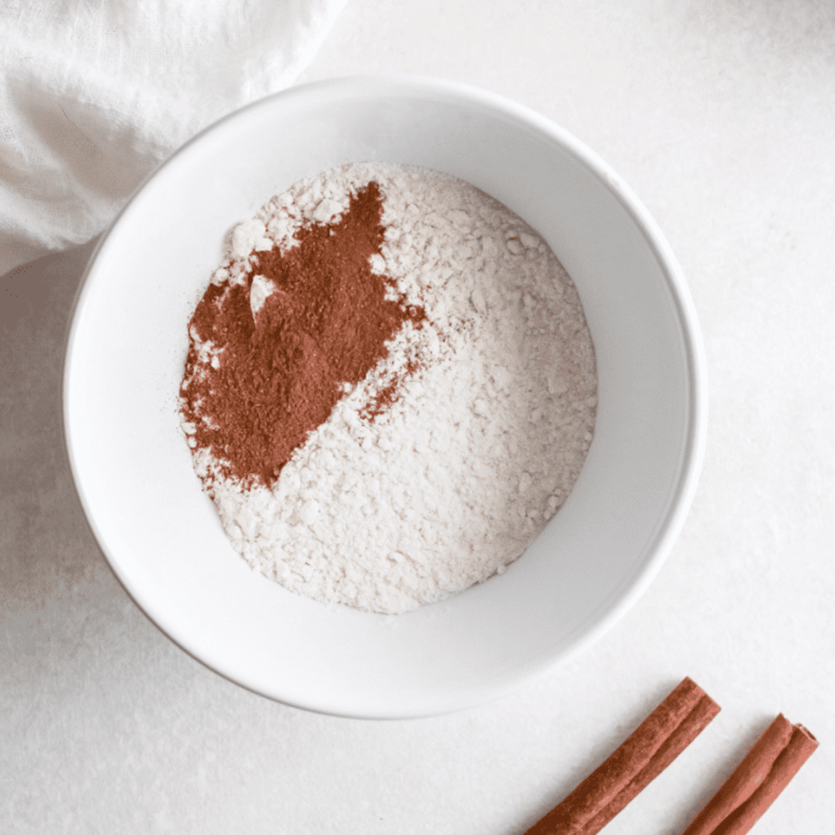 Mixing pumpkin puree, brown sugar, egg, milk, and vanilla, then combining with dry ingredients to make smooth donut batter.