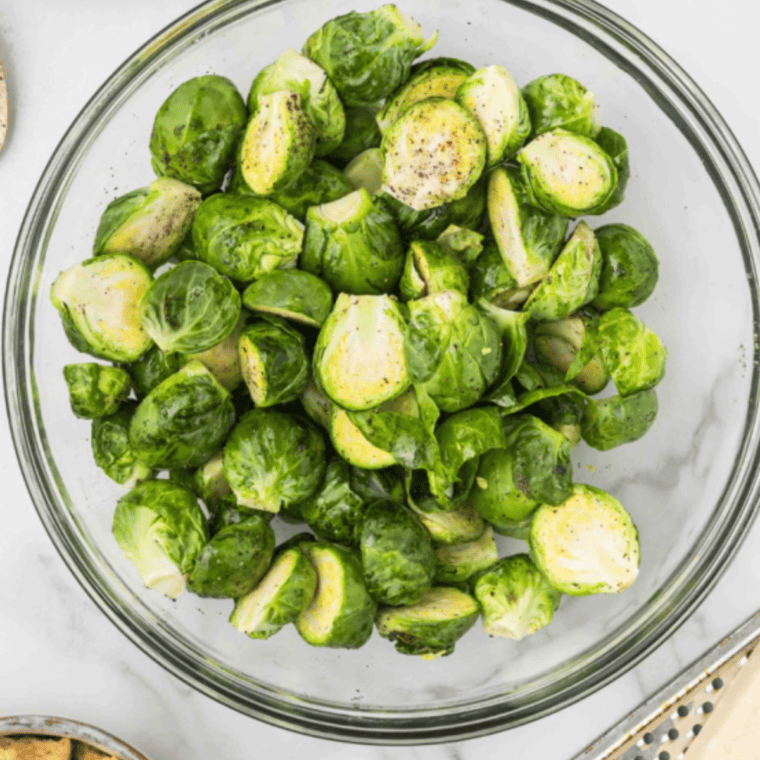  Trim and clean Brussels sprouts, removing tough outer leaves and cutting in half for even cooking.