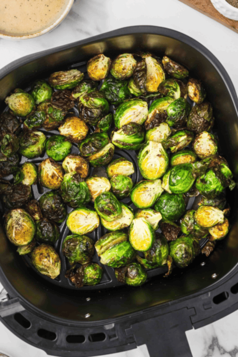 Golden brown, crispy Brussels sprouts cooked in an air fryer with a spicy maple glaze.