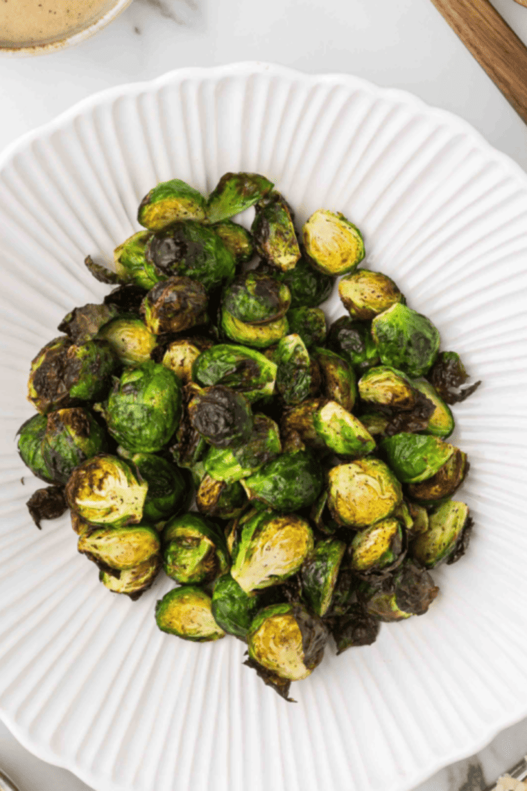 Crispy Brussels sprouts drizzled with a sweet and spicy glaze, just like Longhorn Steakhouse.