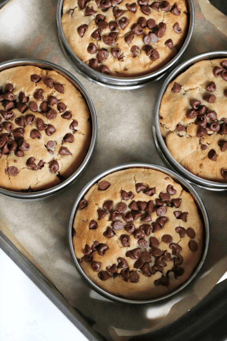 Serving freshly baked chocolate chip cookies warm or storing in a container.