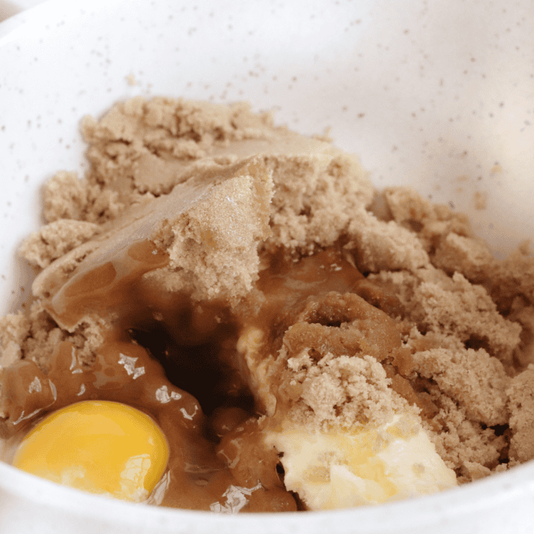 Mixing eggs and vanilla into the butter-sugar mixture until smooth.