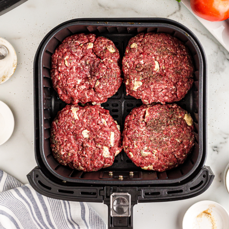 Burger patties cooking in the air fryer.