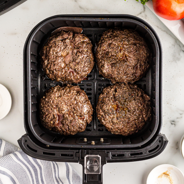 Melting cheese on cooked burger patties in the air fryer.