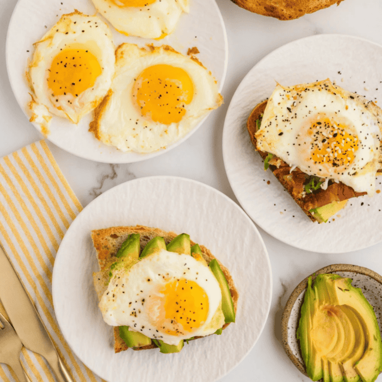 Cooked air fryer eggs resting on a cutting board for breakfast croissant sandwiches