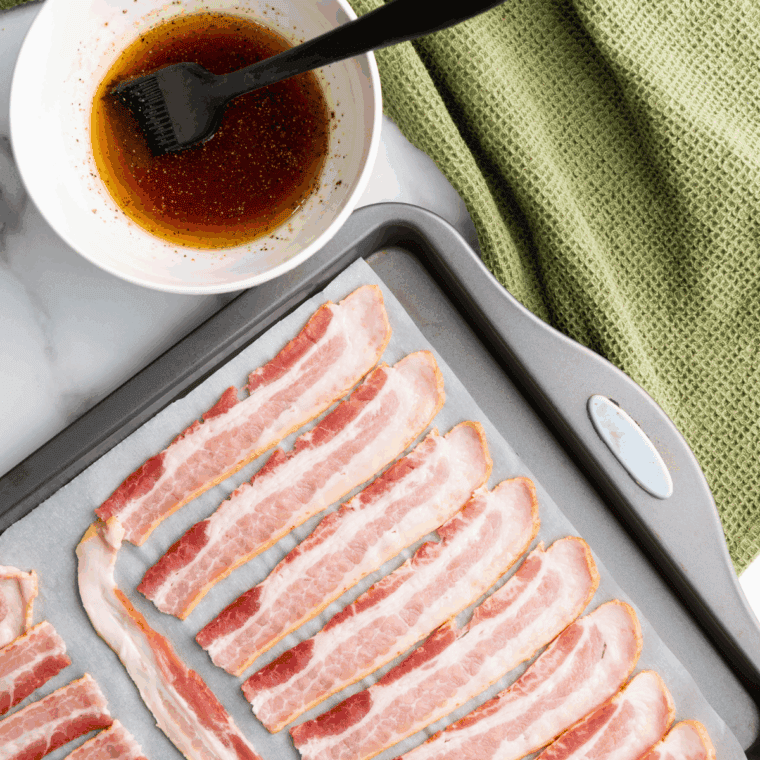 Brush the bacon slices generously with bourbon glaze on both sides, ensuring they are well-coated for maximum flavor.