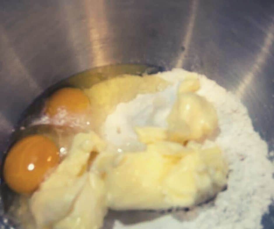 In a large mixing bowl, mix together the flour, baking soda, salt, butter, sugar, brown sugar, eggs, and vanilla extract.