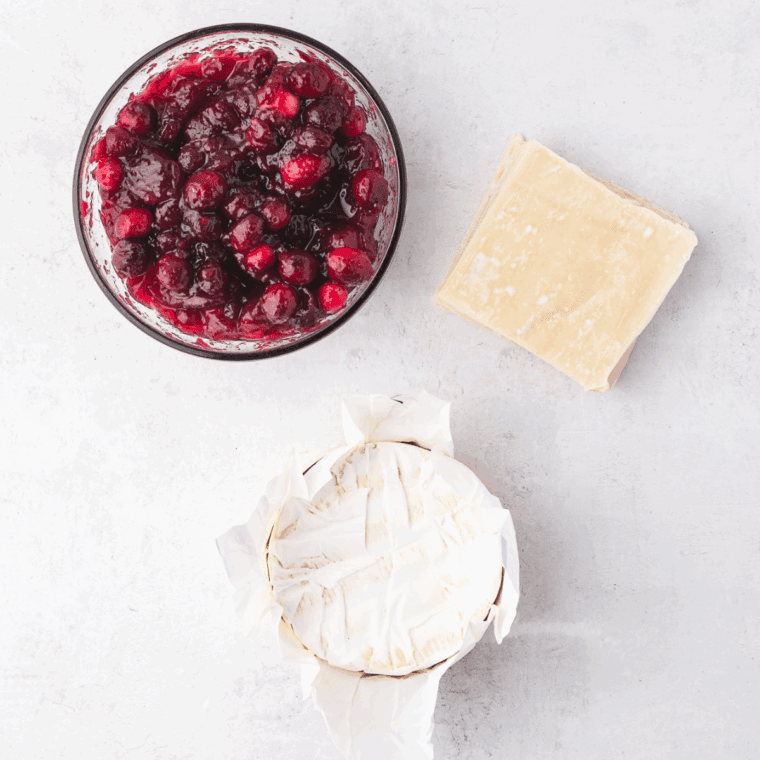 Ingredients needed for Air Fryer Cranberry Brie Bites on kitchen table.