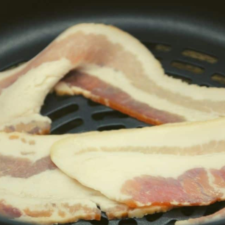 Prepare the bacon in the air fryer basket.