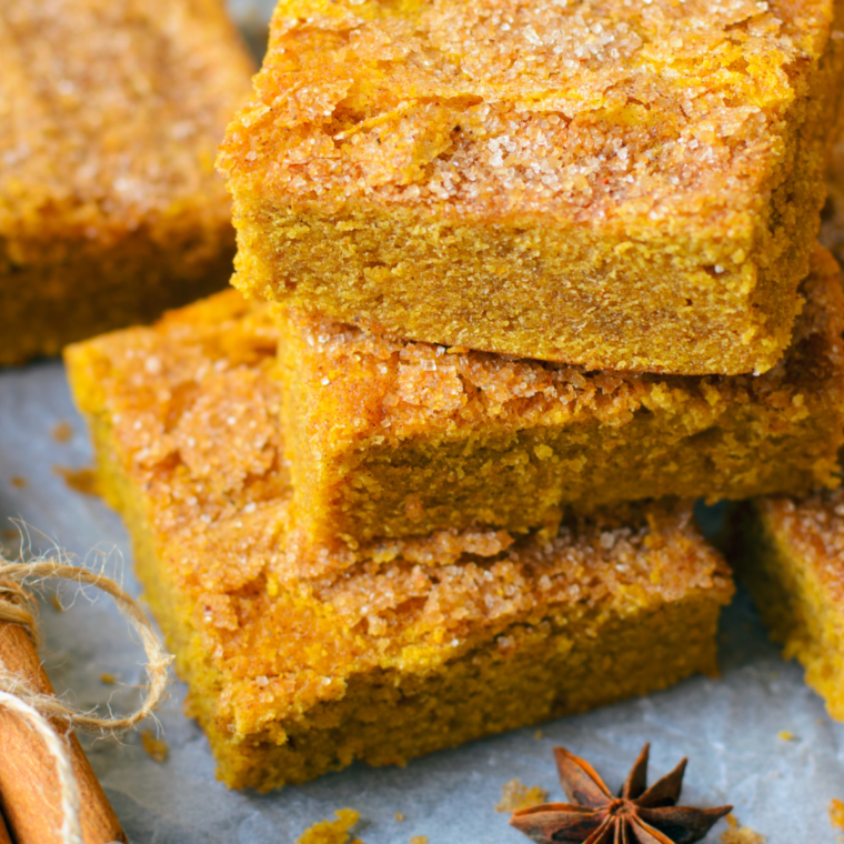 Air Fryer Pumpkin Pie Squares served on a festive fall-themed platter, garnished with whipped cream and a sprinkle of cinnamon.