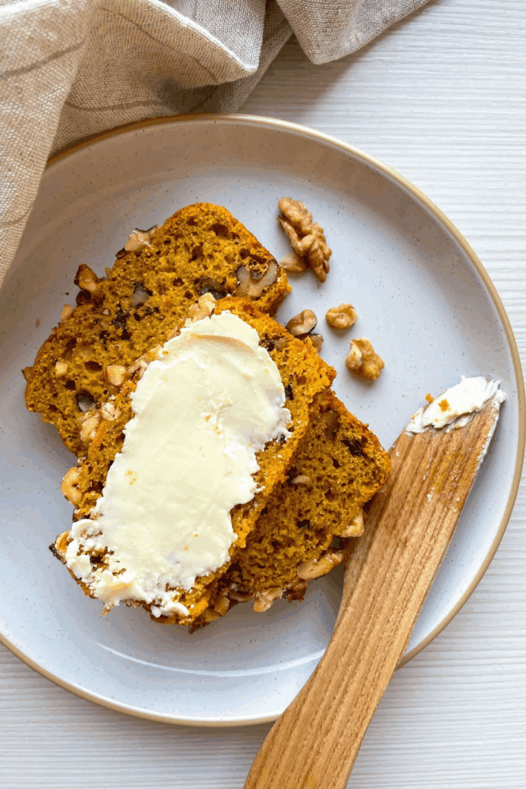 Homemade Bob Evans Pumpkin Bread loaf sliced on a wooden board, showing its moist, spiced interior.