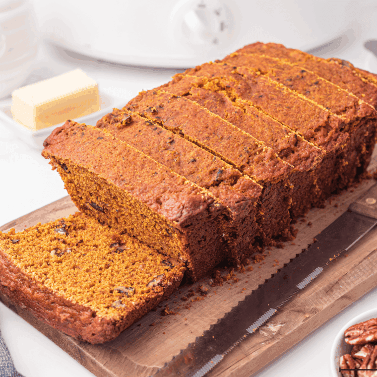 Freshly baked Bob Evans pumpkin bread loaf sliced on wooden board with warm spices