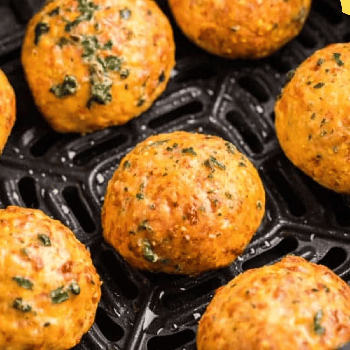 Golden, cheesy Red Lobster biscuits served fresh from the air fryer on a white plate.