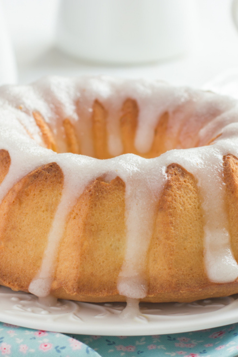 Air fryer lemon bundt cake topped with lemon glaze and fresh zest
