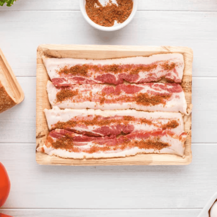 Mixing brown sugar, maple syrup, cayenne, black pepper, and red pepper flakes in a small bowl for Air Fryer Millionaire’s Bacon.