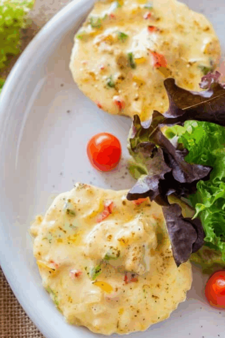 Golden-brown air fryer scallops on the half shell with creamy sauce and crispy breadcrumb topping