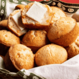 Golden, fluffy Cracker Barrel-style cornbread muffins on a plate, awaiting serving.