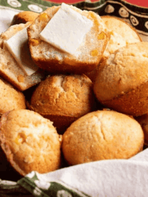Golden, fluffy Cracker Barrel-style cornbread muffins on a plate, awaiting serving.