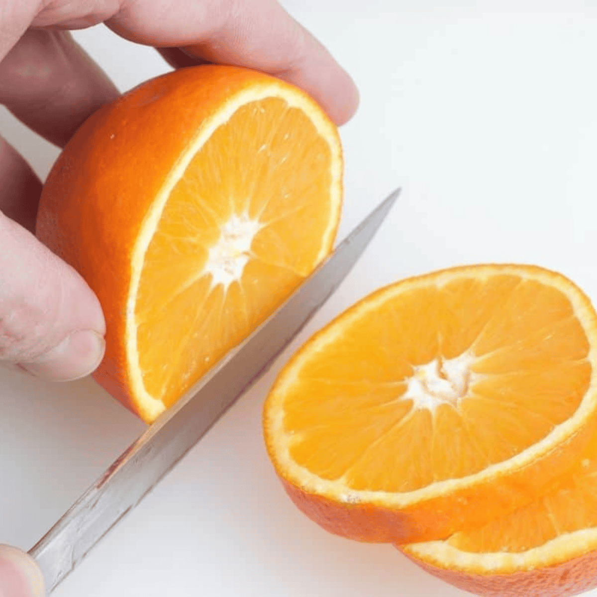Washing oranges thoroughly and slicing them into even pieces about 1/4 to 1/2 inch thick for even drying.