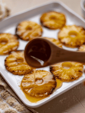 Honey Glazed Air Fryer Pineapple slices golden and caramelized on a plate