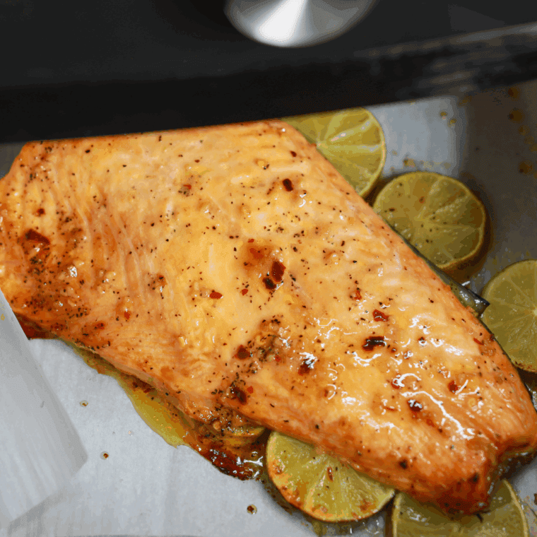 Air fryer garlic butter salmon fillets, golden and flaky, served on a plate.
