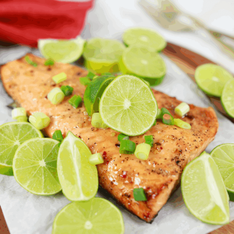 Plated garlic butter salmon ready to enjoy, topped with extra sauce.