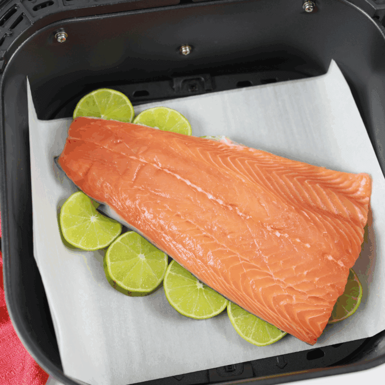 Skinless salmon fillet seasoned with salt and black pepper, ready for cooking.