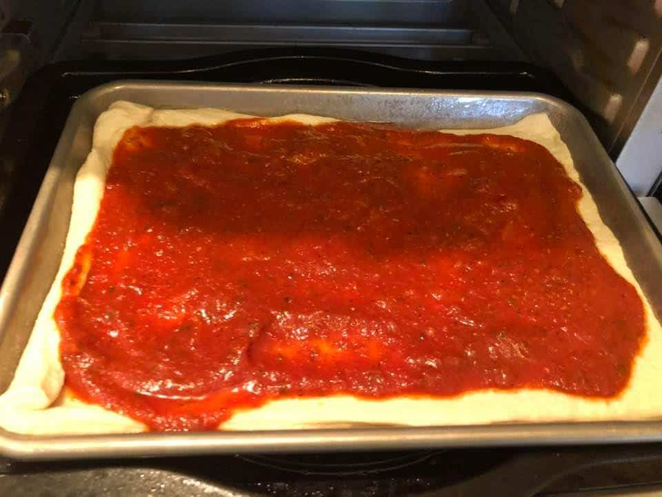 Spread the pizza sauce all over the crust.