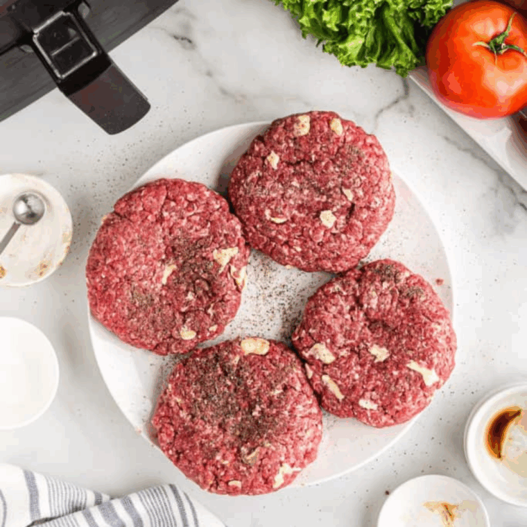 Cooking burger patties in the air fryer.