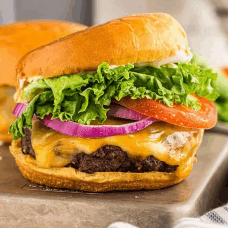 Juicy A&W Teen Burger copycat with melted cheese, lettuce, and pickles on a toasted bun.