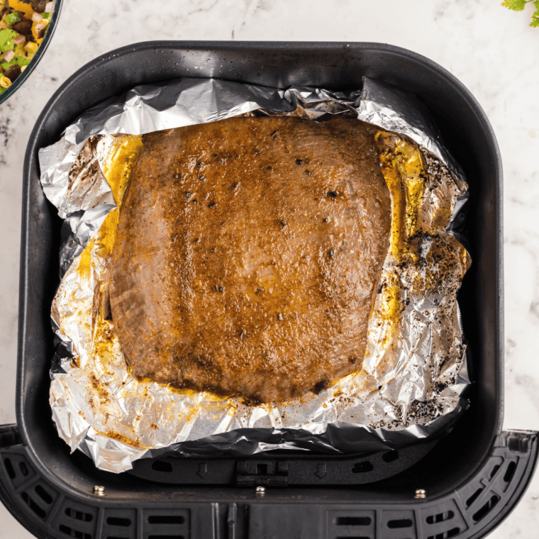 overhead: air fried flank steak in air fryer basket