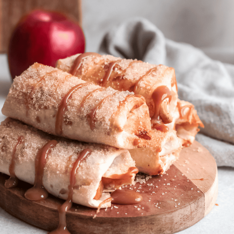 Crispy air fryer apple pie taquitos served warm with a scoop of vanilla ice cream