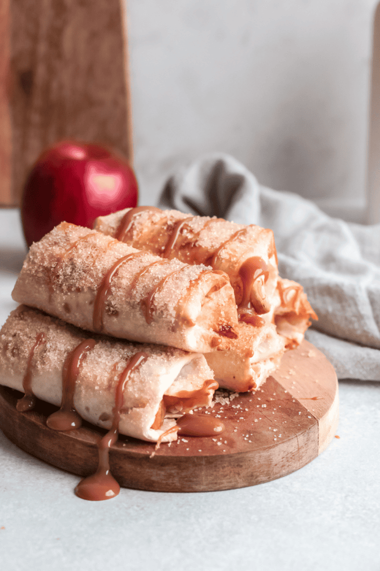 Air fryer apple pie taquitos rolled in cinnamon sugar and drizzled with caramel