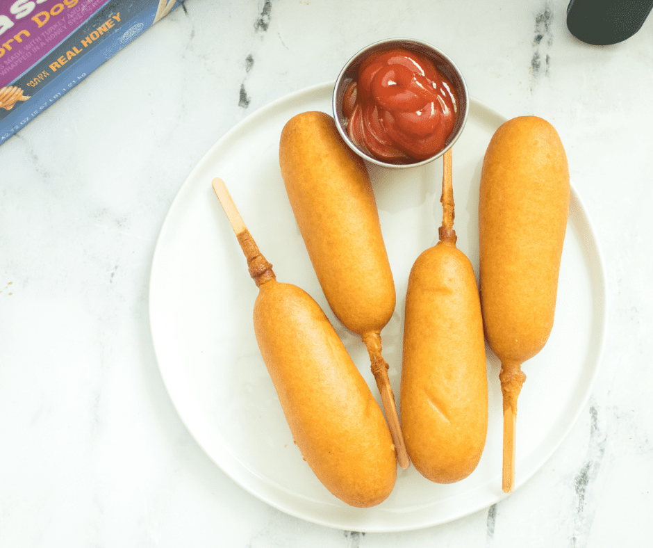 overhead of plated air fryer corn dogs on a marble counter