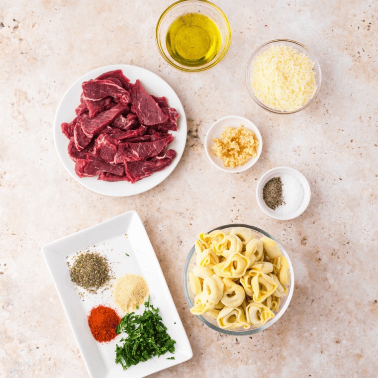 Ingredients needed for Air Fryer Parmesan Crusted Steak on kitchen table.