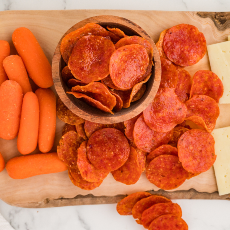 Close-up of crispy Air Fryer Pepperoni Chips with a dipping sauce.