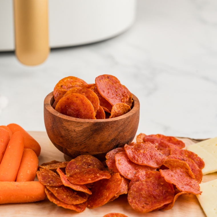 Close-up of crispy Air Fryer Pepperoni Chips with a dipping sauce.