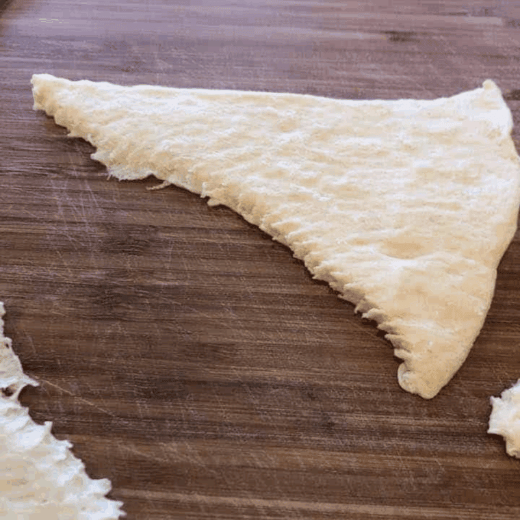 Lay the biscuit dough onto the cutting board.