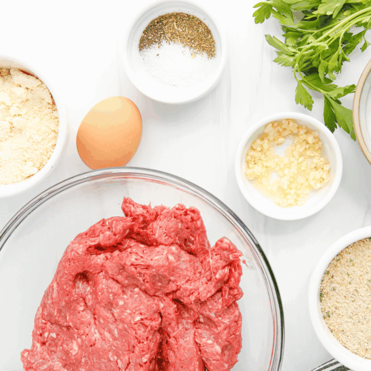 Ingredients needed for Air Fryer Sausage Meatballs on kitchen table.