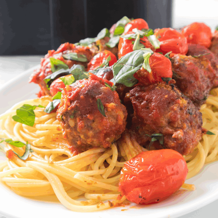Golden, crispy Air Fryer Sausage Meatballs served on a plate with marinara sauce for dipping.