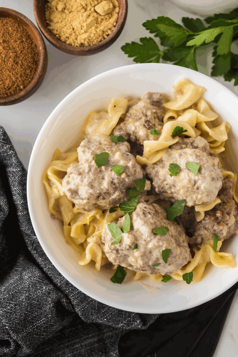 Golden brown and crispy Air Fryer Sausage Meatballs served with marinara sauce for dipping.