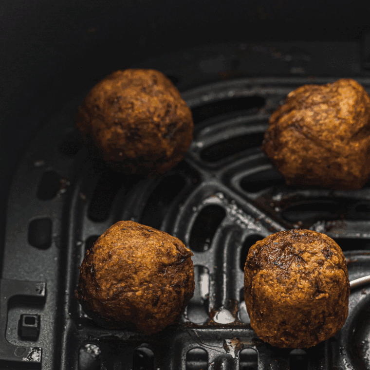 Golden brown Air Fryer Sausage Meatballs served with marinara sauce for dipping, crispy on the outside and tender inside.