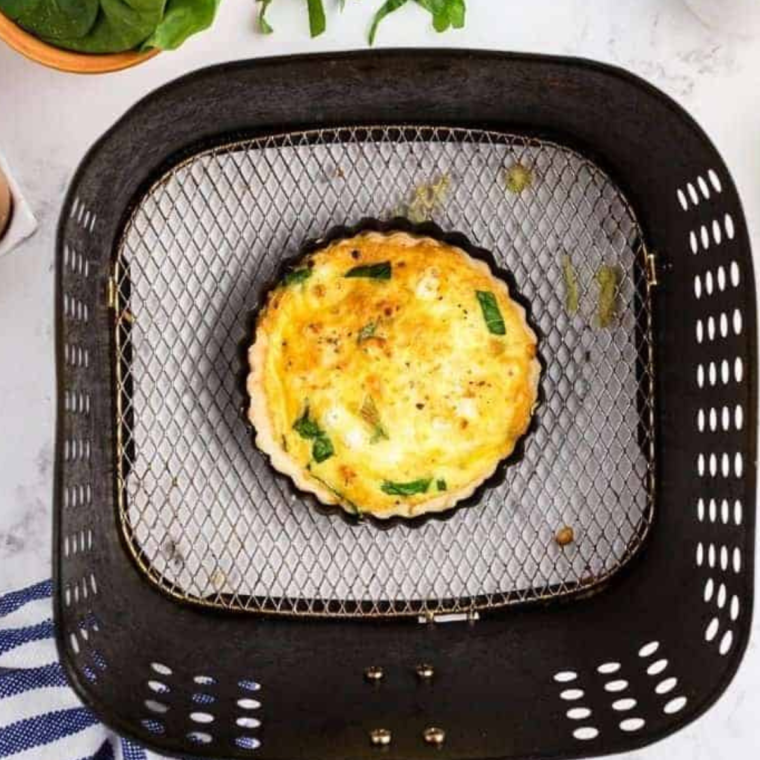 Place Air Fryer Spinach Feta Quiche in the air fryer basket, cooking until set.