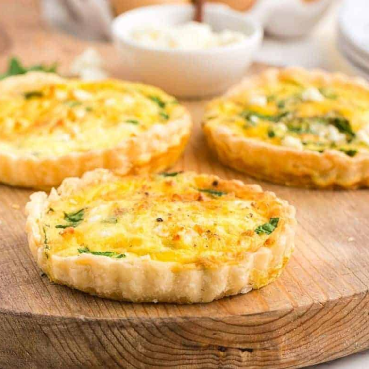 "Freshly made Air Fryer Spinach Feta Quiche with spinach and cheese"