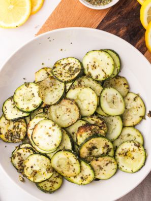 Crispy air fryer zucchini slices golden brown and lightly seasoned on a plate