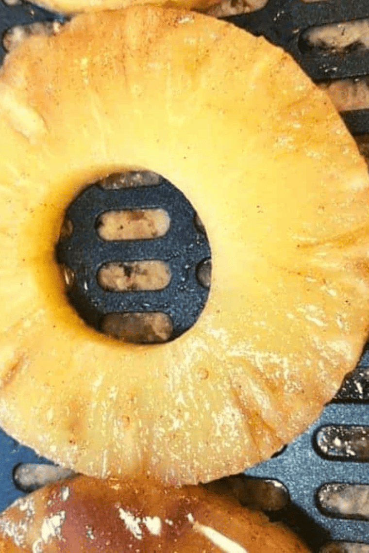 Drizzling fresh lime juice over warm air fried pineapple ready to serve.